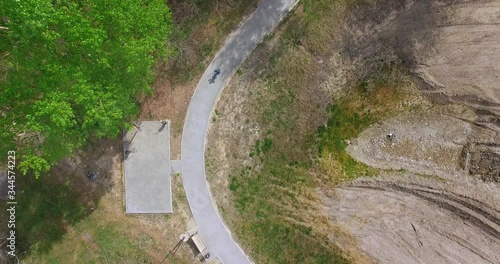 baby on bike rides along the path in the Park, the view from the drone