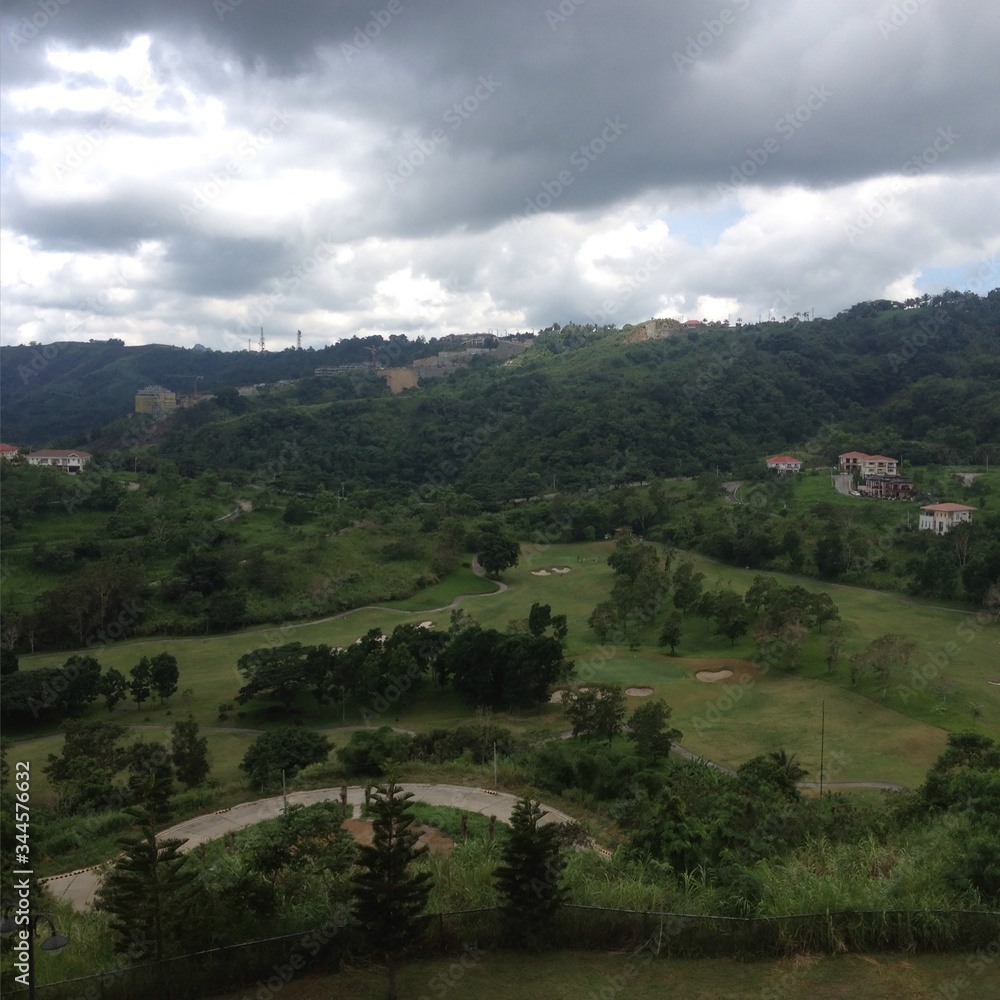 landscape with green hills and clouds