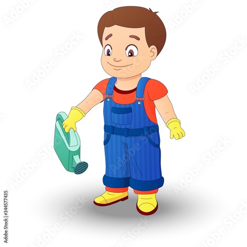 Smiling boy in a denim overall holds watering can