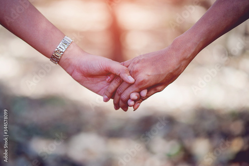Lovers holding hands Two lovers holding hands to give each other warm love on the day of love Family day © FOTO SALE