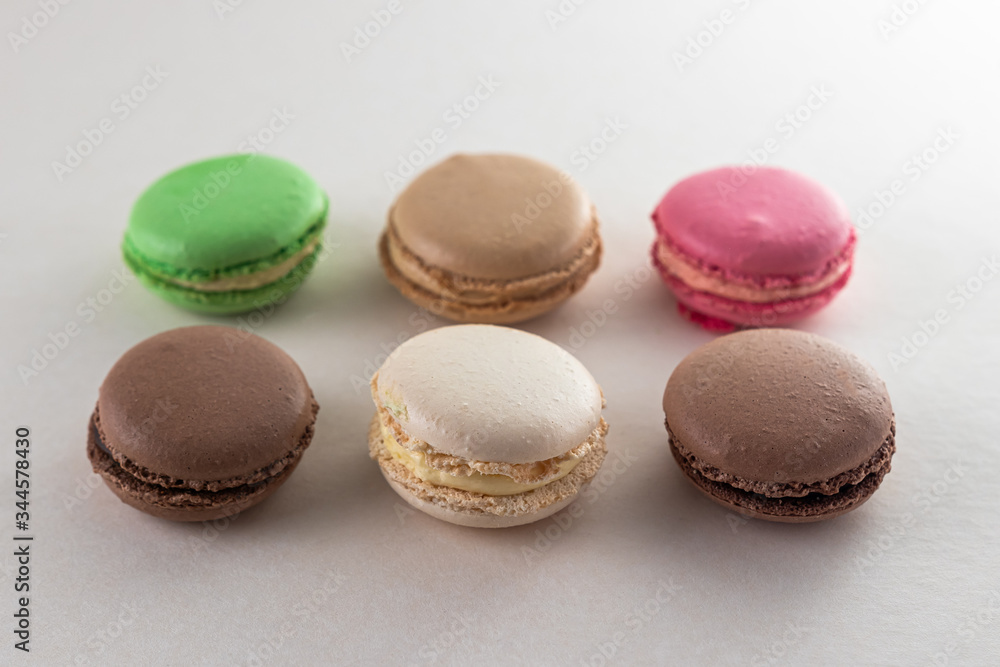 colored macaroon cakes on a light background, pattern colored macaroon cakes on a light background, pattern