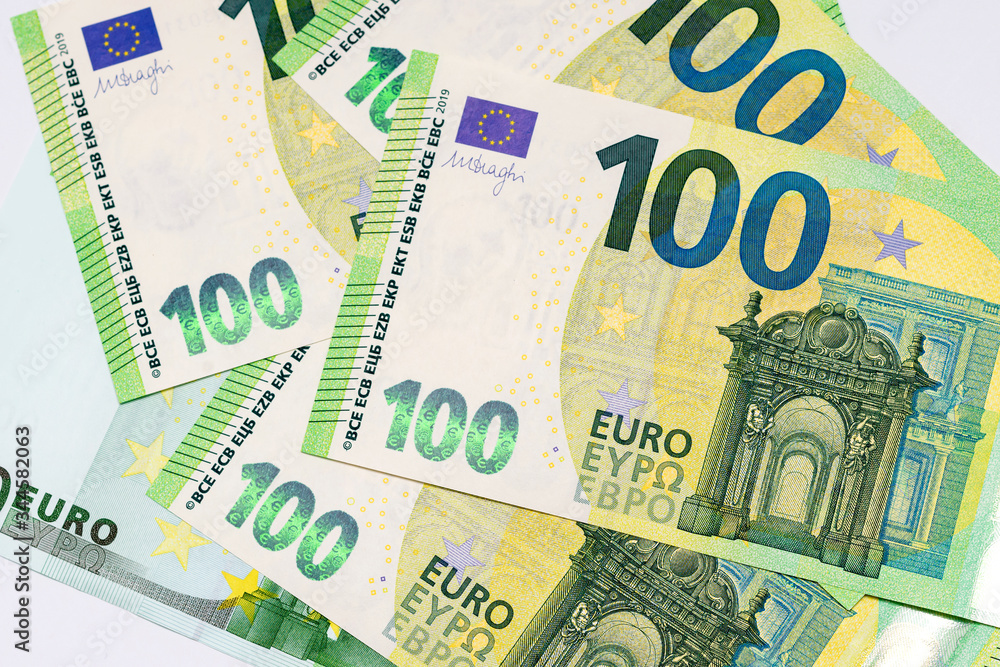 several banknotes of 100 euros close-up on a white background several banknotes of 100 euros close-up on a white background