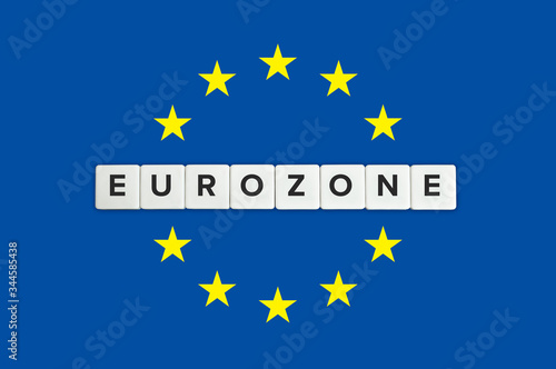 Eurozone or the euro area banner. Block letters and the European union (EU) flag in the background.