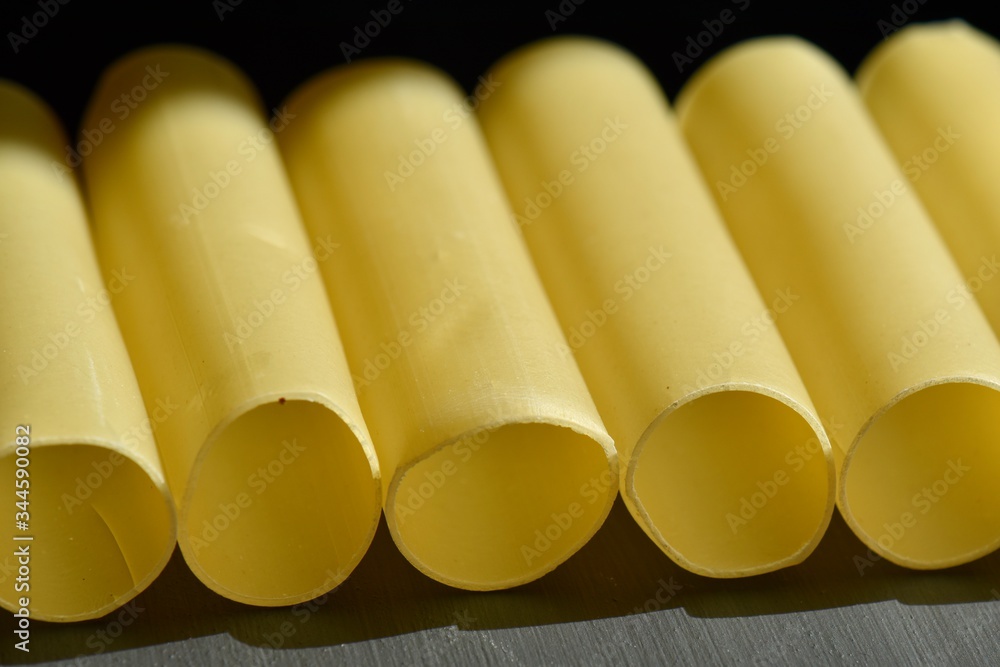 row of cannelloni pasta tubes row of cannelloni pasta tubes