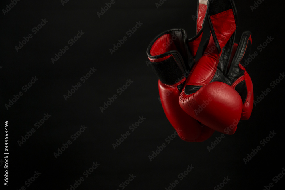 Boxing gloves with black background.