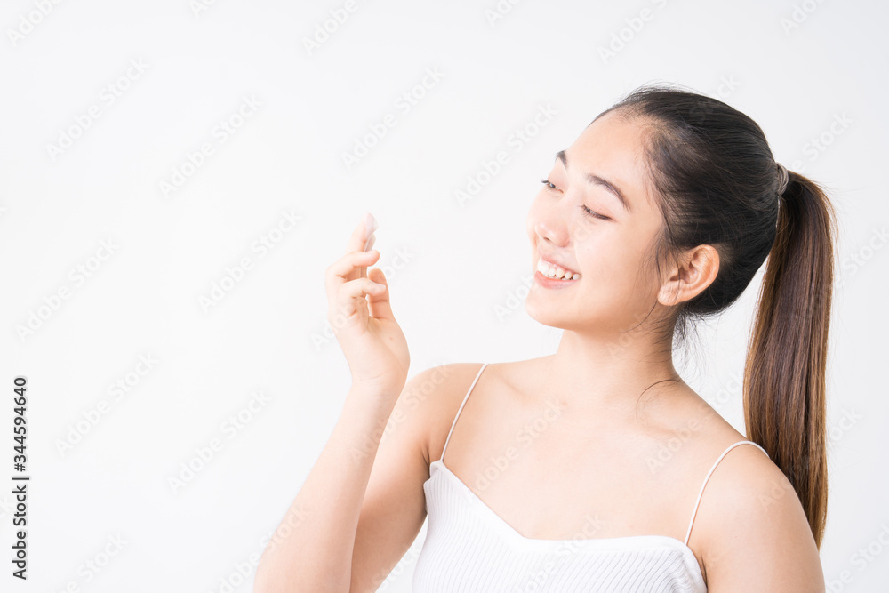 Young women experimenting with skin care creams. Two young woman applyng moisturizing cream. Beauty female with make up concept on the white background. Young women experimenting with skin care creams. Two young woman applyng moisturizing cream. Beauty female with make up concept on the white background.