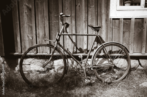 Old bicycle on a wooden wall. Black and white photography