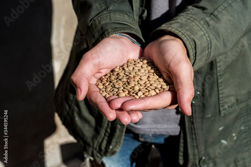 young man with organic lentils in his hands showing the current trend to a healthy and balanced diet