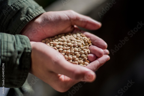young man with organic lentils in his hands showing the current trend to a healthy and balanced diet