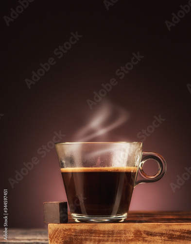 Cup expresso coffee with steam and chocolate