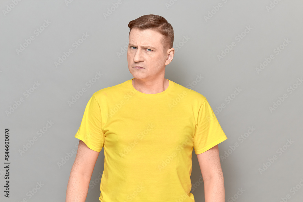 Portrait of serious blond mature man with focused strict expression Portrait of serious blond mature man with focused strict expression