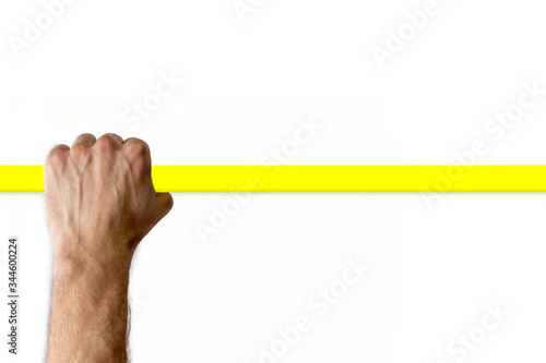 Male hand holding a yellow handrail