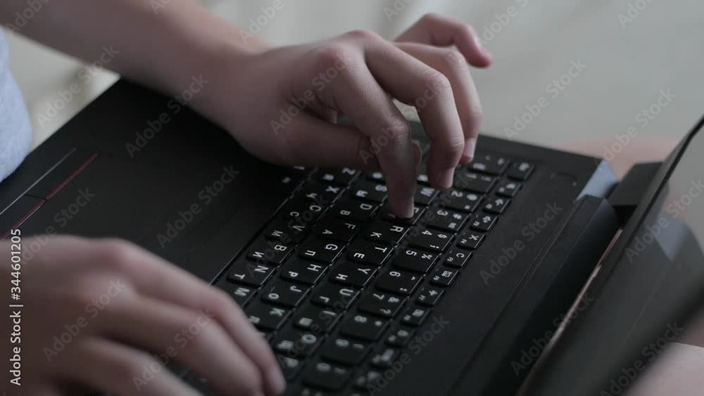 close-up of a child's hands typing on a computer close-up of a child's hands typing on a computer
