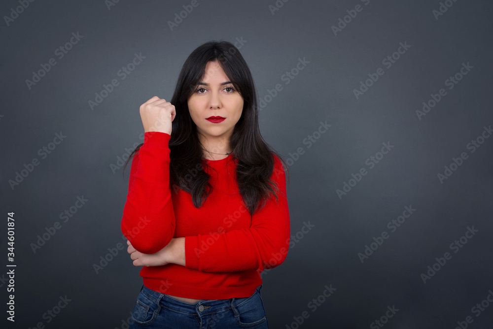Isolated portrait of stylish European woman with hand near face and looking to the camera with doubtful and skeptical expression suspect and doubt. Isolated over gray background. Isolated portrait of stylish European woman with hand near face and looking to the camera with doubtful and skeptical expression suspect and doubt. Isolated over gray background.