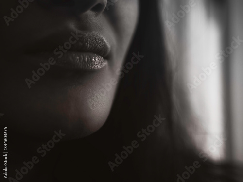 blurred plump female lips dark toned