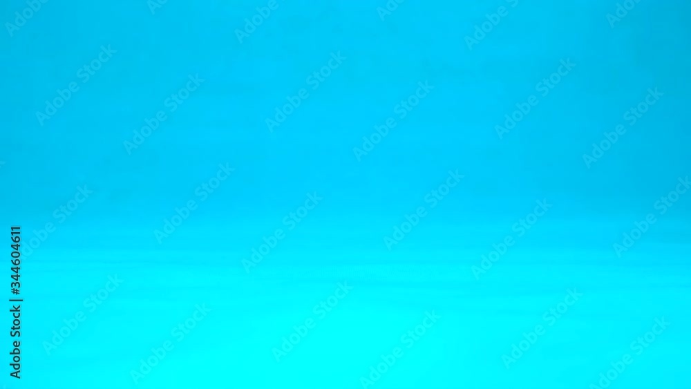 Lime with eyes in a woman hand close-up. Lime shakes and twists eyes on a blue background. Slow motion. Lime with eyes in a woman hand close-up. Lime shakes and twists eyes on a blue background. Slow motion.