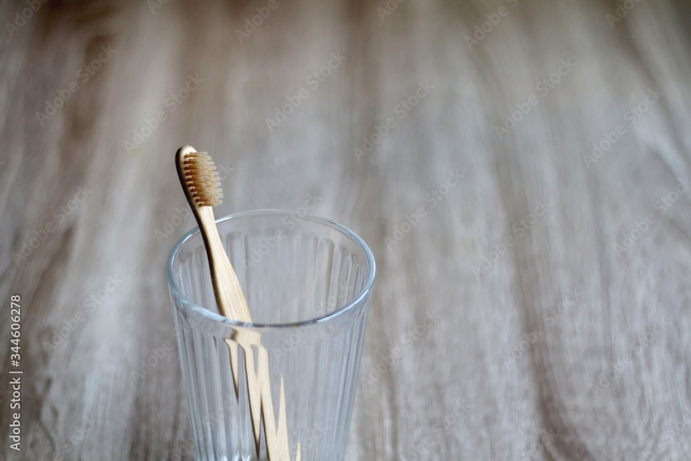 Bamboo toothbrush in a glass. Selective focus.