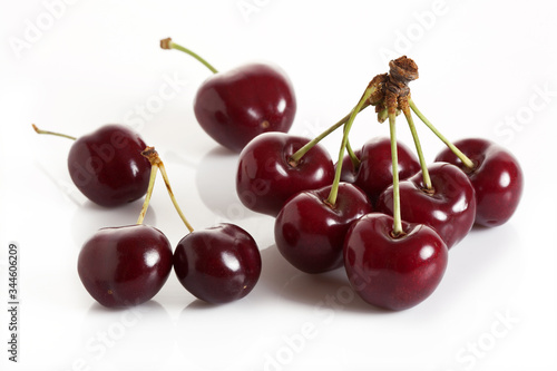 Cherry branch of sweet and fresh cherries on a white background.