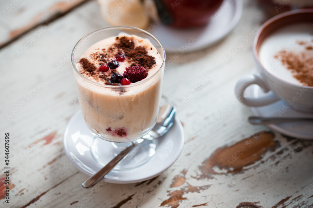 Tiramisu, traditional Italian dessert in glass on a table Tiramisu, traditional Italian dessert in glass on a table