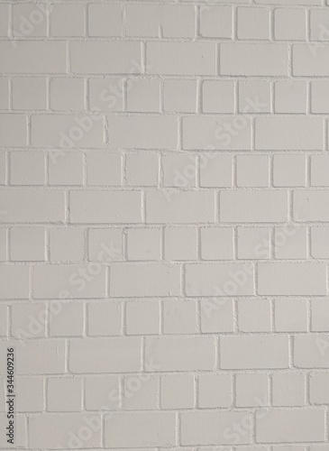 White painted smooth brick wall, for texture or background material. Vertical orientation.