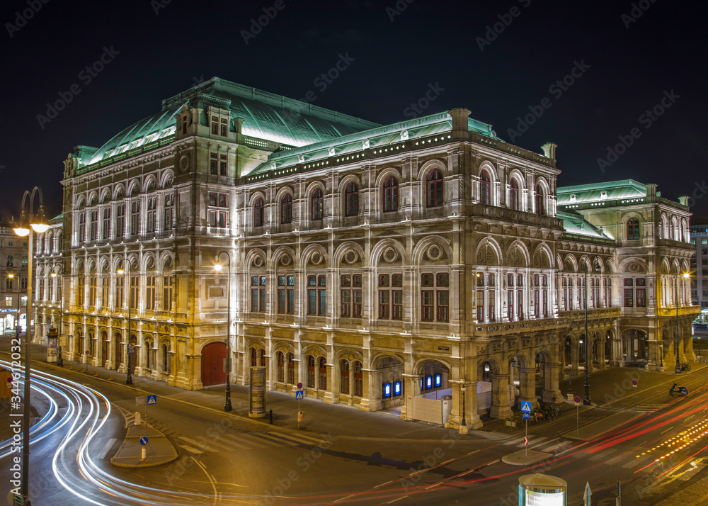 Night image of the Vienna Opera House with blurred traffic lights