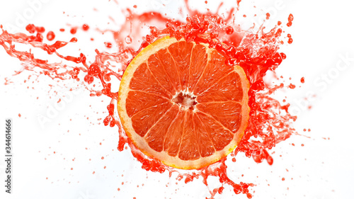 Fototapeta Naklejka Na Ścianę i Meble -  Freeze motion of sliced grapefruit with splashing juice isolated on white background