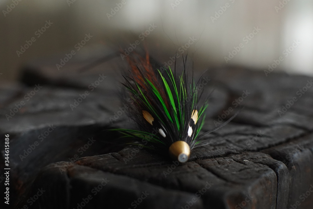 Traditionally dressed salmon fly shot against a wood background