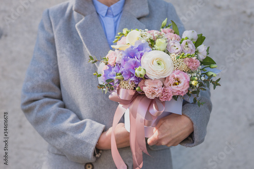Wallpaper Mural Flower arrangement in a pink hat box was created by a florist for a wedding gift. Flower bouquet of blue hydrangea, white Freesia, pink Ranunculus asiaticus, eustoma flowers, roses and eucalyptus Torontodigital.ca