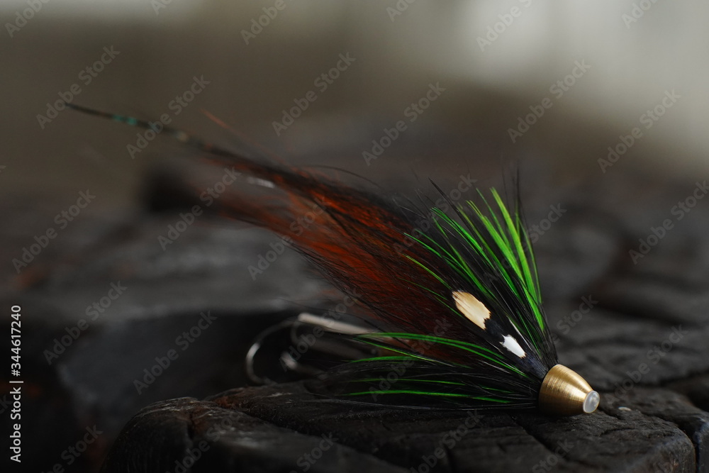 Traditionally dressed salmon fly shot against a wood background