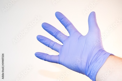 Purple glove on hand coronavirus