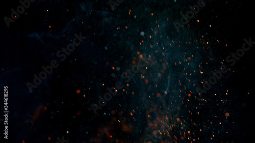 fire flames with sparks on a black background, close-up photo