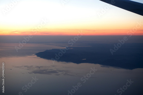 Sunset landscape view of the coast from the plane.