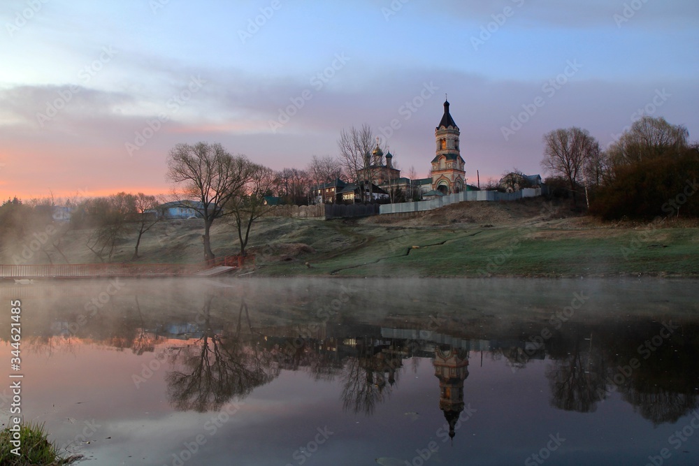 Landscape with church and river in early morning