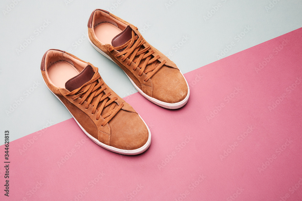 Brown casual shoes for men on colorful background.