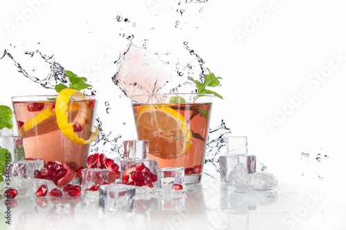 summer pomegranate drink with lemon and mint with splashed water and ice photo