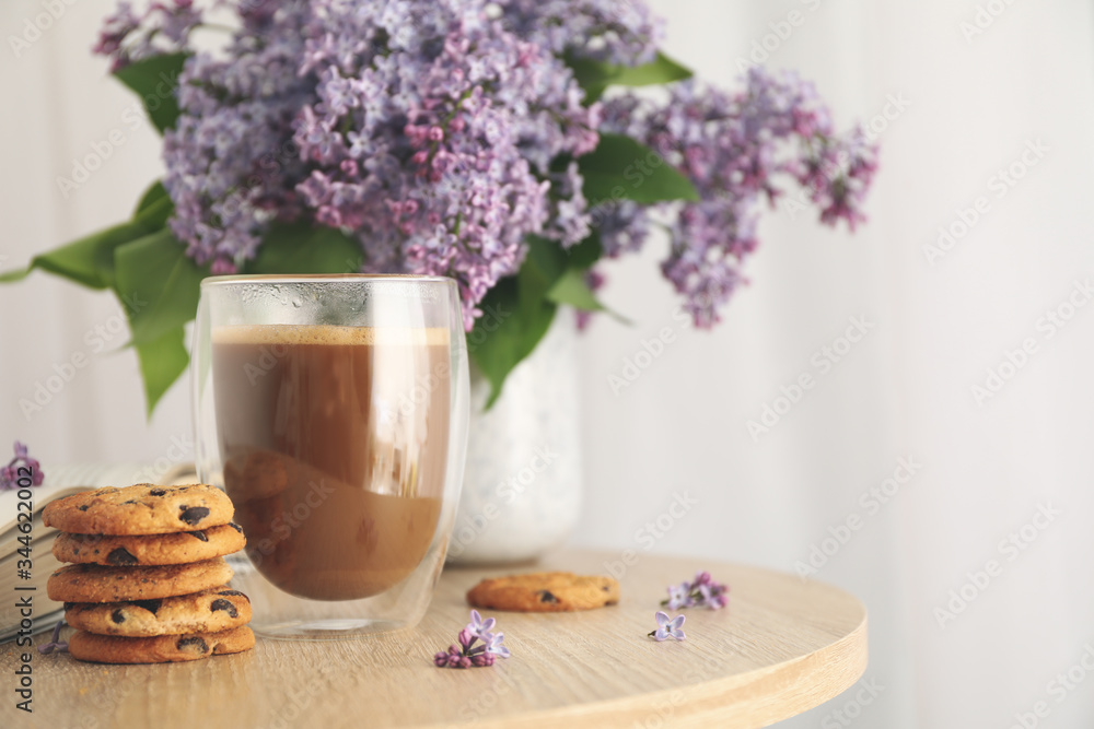 Composition with chocolate chip cookies, cocoa and lilac on wooden table