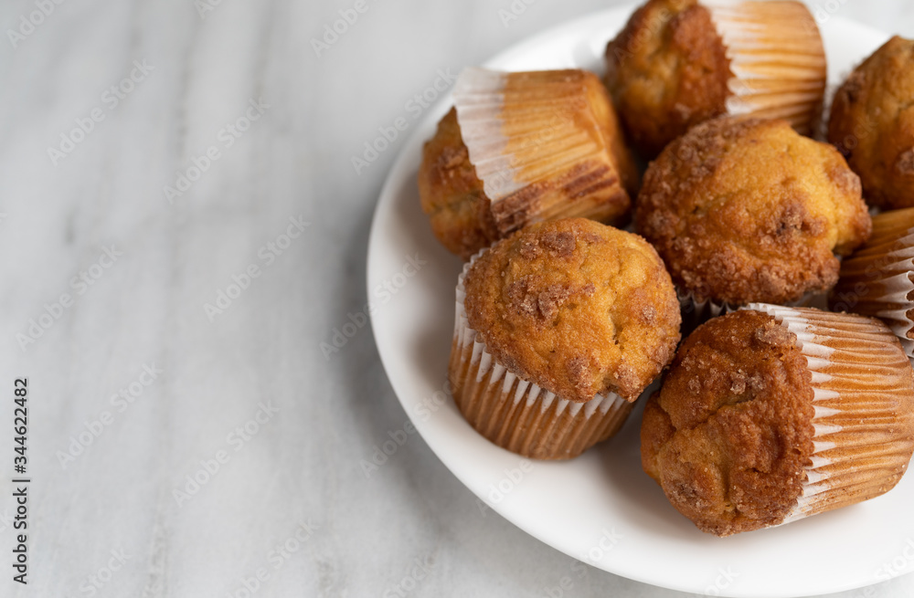 Banana Streusel muffins on a white plate Banana Streusel muffins on a white plate