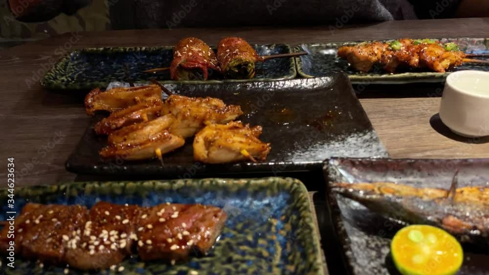 4K, Set of delicious traditional skewers grilled for dinner. Popular Japanese variety food in the restaurant. Appetizing Japan skewer plate on wooden table. -Dan 4K, Set of delicious traditional skewers grilled for dinner. Popular Japanese variety food in the restaurant. Appetizing Japan skewer plate on wooden table. -Dan