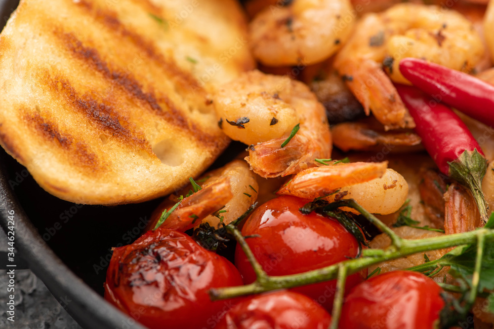 close up view of fried shrimps with grilled bread, tomatoes, chili peppers close up view of fried shrimps with grilled bread, tomatoes, chili peppers