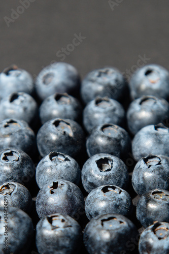 Blueberry antioxidant organic superfood in concept for healthy eating and nutrition.  Blueberries on gray background