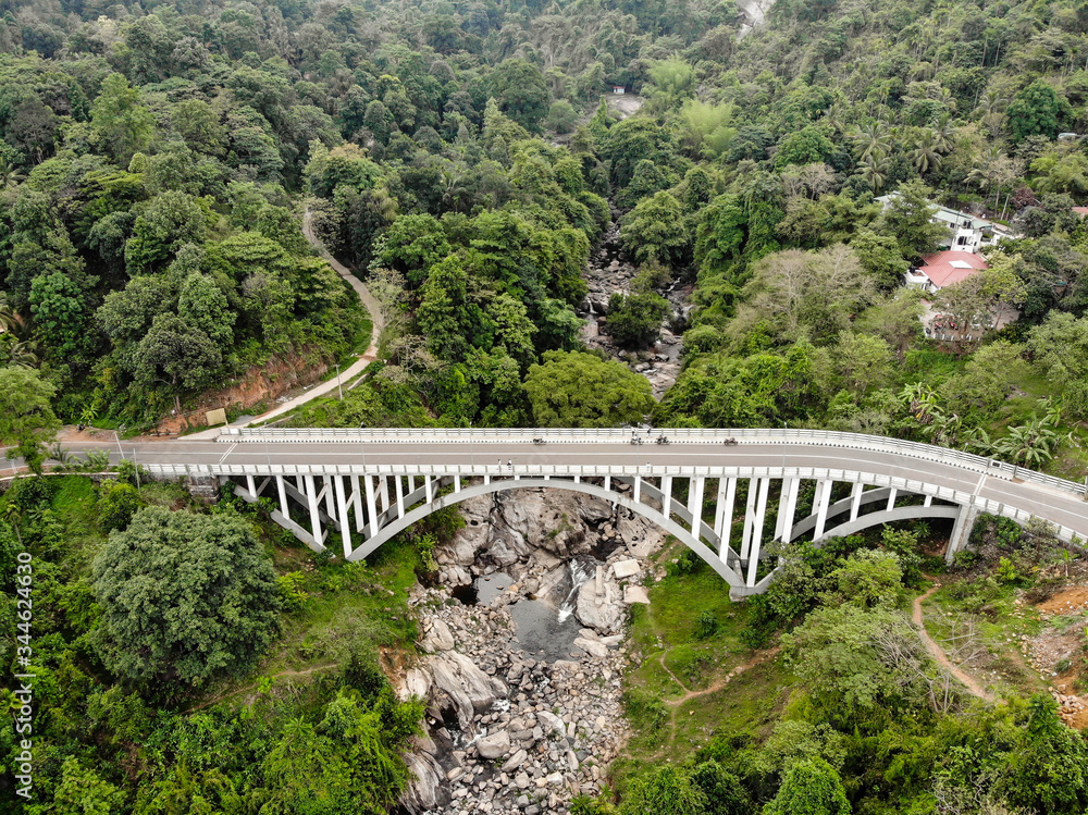 Arial view Arc bridge over the mountain river Arial view Arc bridge over the mountain river