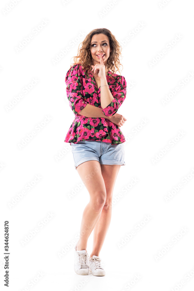 Cute happy summer girl with finger on lips having secret gossip or silent gesture looking up. Full body length isolated on white background. Cute happy summer girl with finger on lips having secret gossip or silent gesture looking up. Full body length isolated on white background.