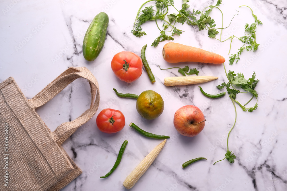 fresh vegetables and fruits with shopping bag on tiles background fresh vegetables and fruits with shopping bag on tiles background