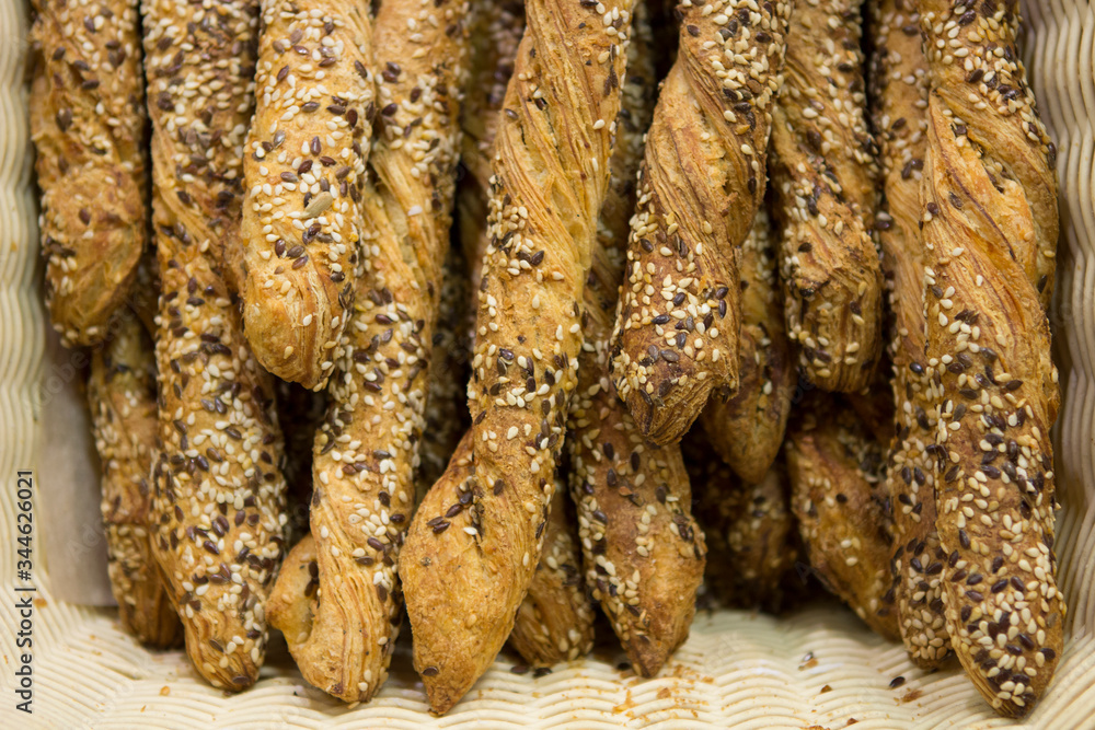 Homemade Cinnamon Twists, croissant puff pastry rolls with sesame seeds and cheese on the counter of a bakery shop Homemade Cinnamon Twists, croissant puff pastry rolls with sesame seeds and cheese on the counter of a bakery shop