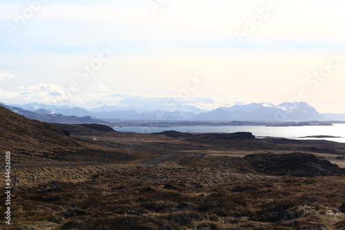 The shoreline of the ocean and beautiful snow-capped mountains on the horizon. The Landscape Of Iceland