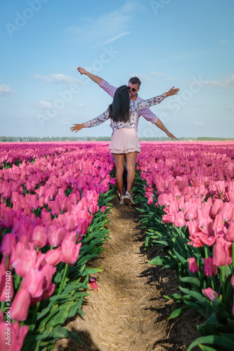 Tulip fields in the Netherlands, couple men and woman in flower field during Spring in the Nethertlands photo