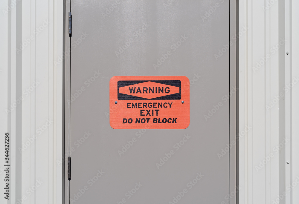 Emergency exit warning sign on a door Emergency exit warning sign on a door