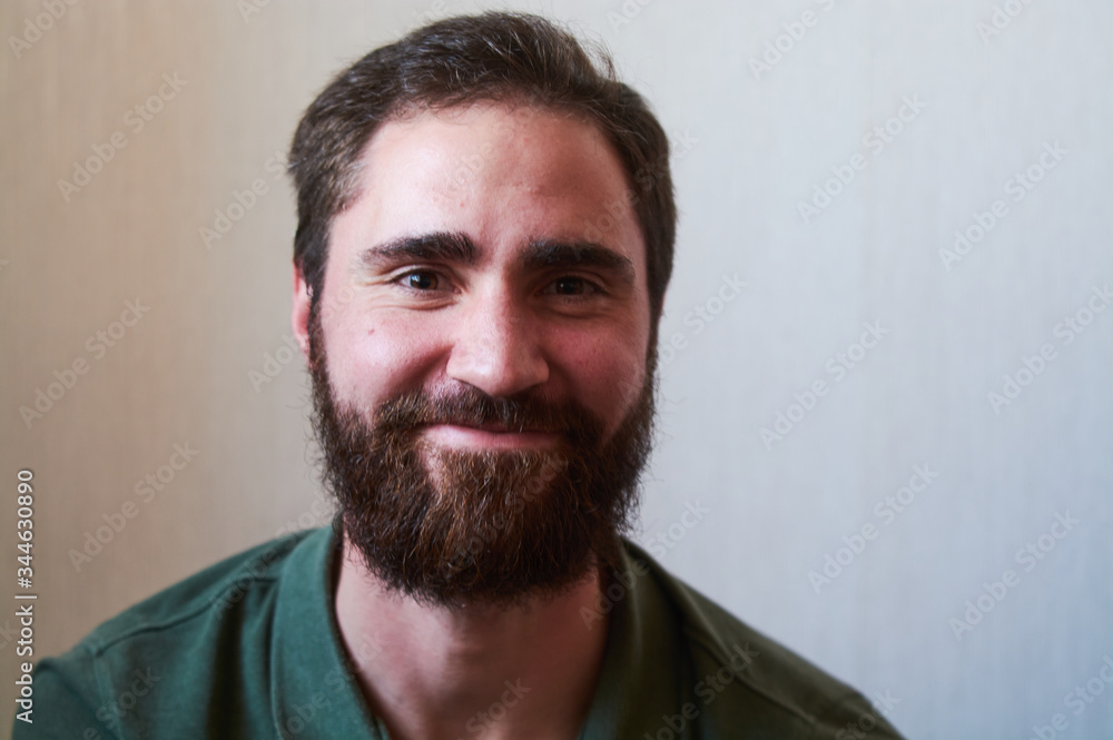 Portrait of young guy with dark beard with various emotions on his face in green shirt. Portrait of young guy with dark beard with various emotions on his face in green shirt.