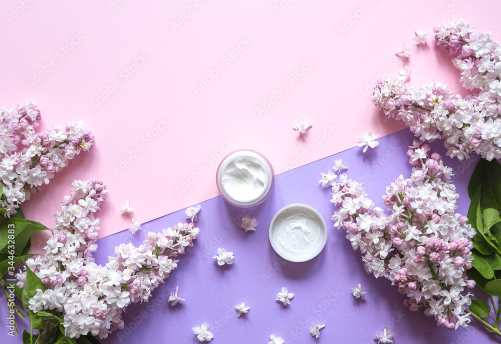 Natural cosmetics product with lilac flowers and jar creme on a purple background. Spa, skin care, body treatment. Top view and copy space flat lay. Natural cosmetics product with lilac flowers and jar creme on a purple background. Spa, skin care, body treatment. Top view and copy space flat lay.