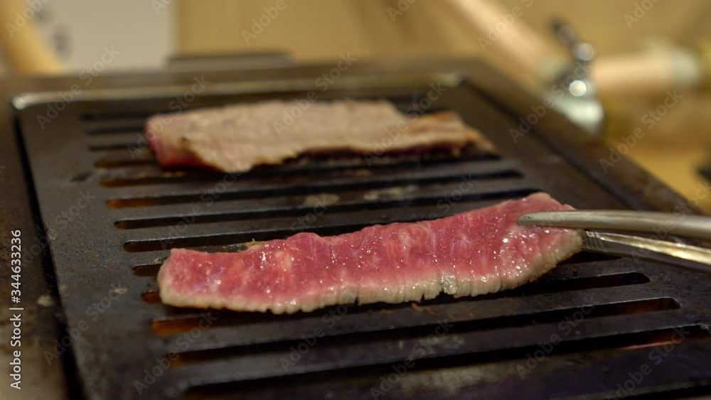 Slow Motion of premium and fresh wagyu beef raw sliced served for japanese barbecue of Sukiyaki. Yakiniku is a Japan style grilled for meat. Shabu BBQ -Dan Slow Motion of premium and fresh wagyu beef raw sliced served for japanese barbecue of Sukiyaki. Yakiniku is a Japan style grilled for meat. Shabu BBQ -Dan
